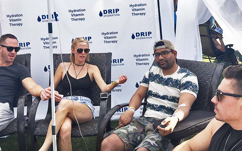 A group of people sitting around each other taking IV therapy