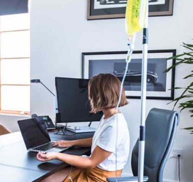 Girl-Receiving-On-Demand-IV-Therapy-in-her-Office-from-DripHydration-x700w-sm Girl Receiving On Demand IV Therapy in her Office from DripHydration