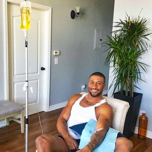 Drip Hydration Mobile IV Therapy - Los Angeles- Man receiving IV at his home, smiling