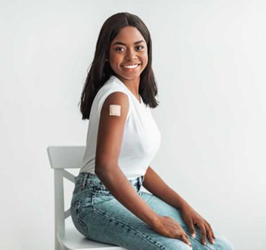 Wellness-Shots woman with a patch on her arm from a vaccine, smiling