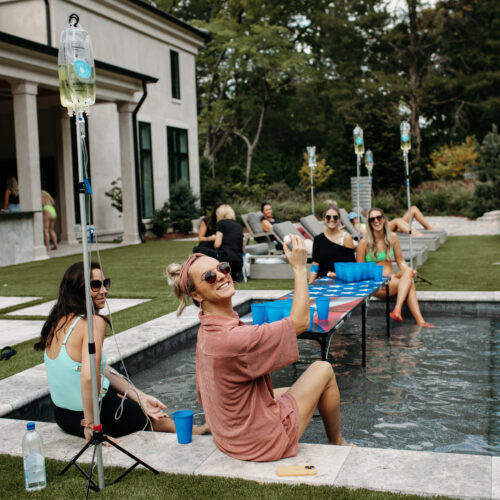 Hydration Drip people getting IV therapy at their home by the pool
