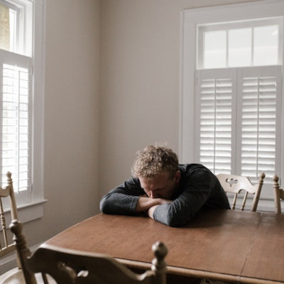 depressed-man man leaning on a table, sad and depressed