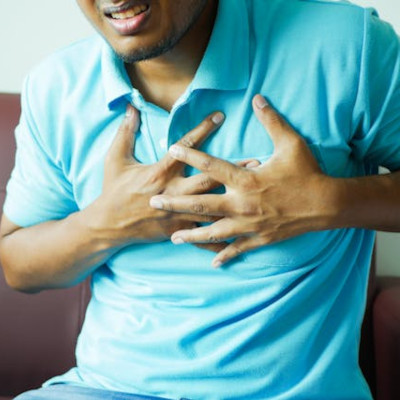 Man with Hands on Chest, experiencing chest pain